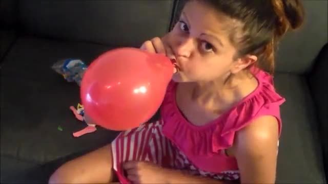 Yesenia blows balloons and pops them with her nails