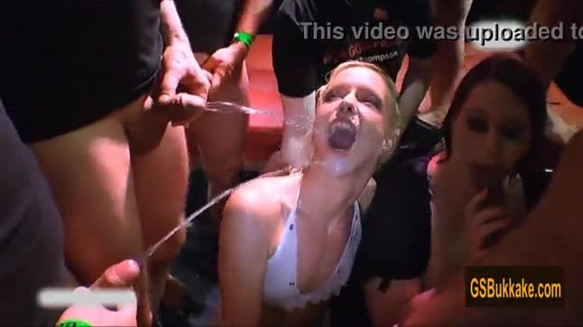 Amateur girls blow while being pissed on by a group of cocks